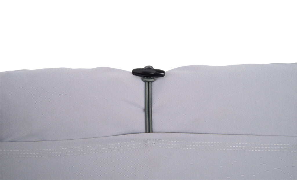 Close-up of a gray quilt with a zipper on a white background