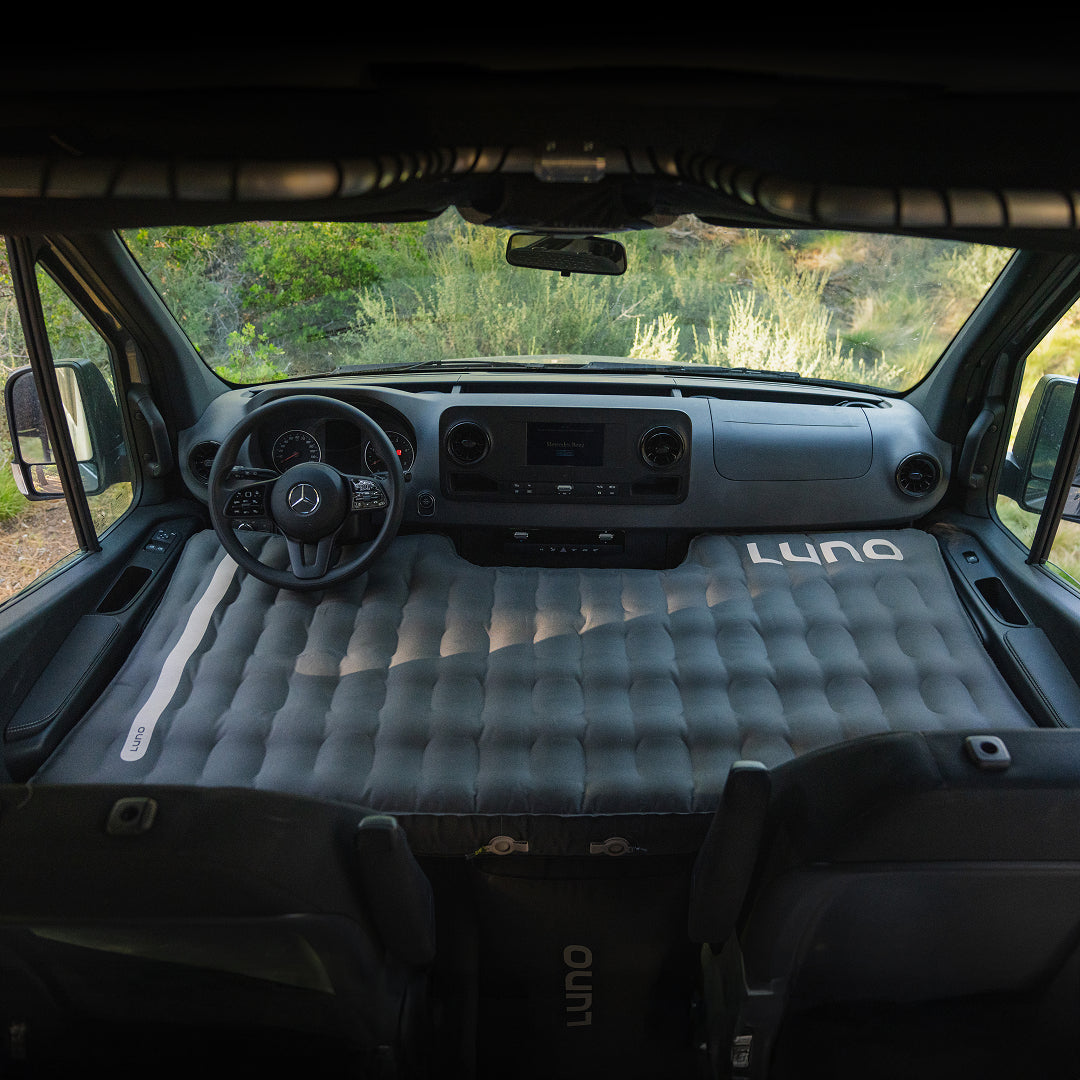 Air pro inflatable mattress fitted to sprinter van front cab seat. Van conversion sleeping solution