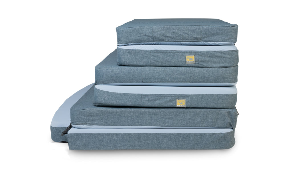 3 different sized sleeping mats folded and stacked on top of each other for size comparison
